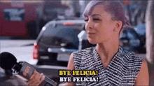 a woman holding a microphone says bye felicia