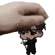 a hand is holding a small cartoon character on top of another cartoon character .
