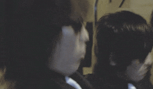 a blurry picture of a man and a woman standing next to each other in a dark room