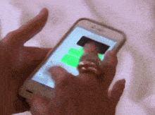 a woman wearing a wedding ring is using a cell phone