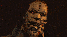 a close up of a mask with red eyes in a dark room