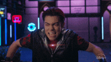 a man with red hair and a disney logo on his shirt