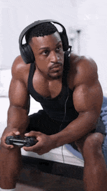 a man wearing headphones is playing a video game .