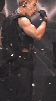 a young man is standing on a stage with his shirt off .