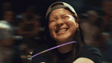 a man wearing glasses is laughing with his mouth wide open