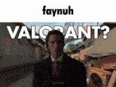 a man in a suit and tie is standing in front of a sign that says " valorant "