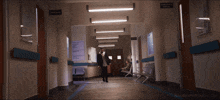 a man standing in a hallway with nandamurifans.com written on the bottom right