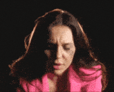a woman in a pink jacket has a black eye on her face