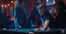 a man is playing pool and the words i win are on the screen