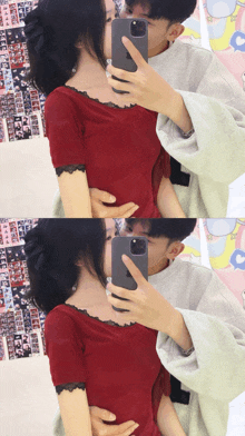 a man is kissing a woman on the neck while taking a picture with his phone