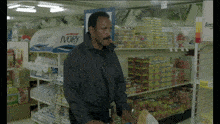 a man standing in front of a shelf that says ivory on it