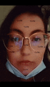 a girl wearing glasses and a face mask has the word cute written on her face