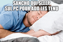 a man in a blue shirt is sleeping on a bed with white sheets