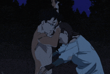 a man without a shirt is hugging a woman in a blue shirt