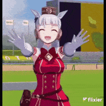 a girl in a red dress and white gloves is standing on a race track .