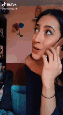 a woman is talking on a cell phone with the hashtag tiktok at the bottom