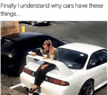 a woman is sitting on the back of a car with a table attached to it