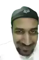 a man wearing a black hat with the fox logo on it
