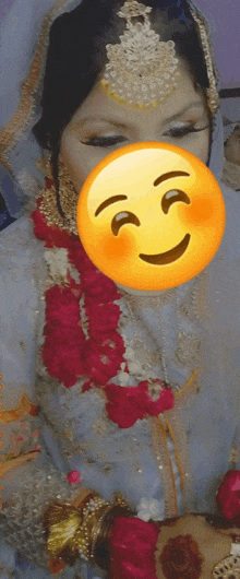 a woman in a white dress with a yellow smiley face covering her face