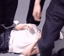 a person laying on the floor with their hands on their chest