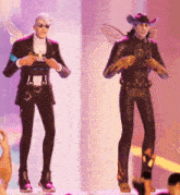 a man in a suit and a woman in a cowboy hat are standing on a stage