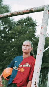 a woman wearing a blue and red shirt with nicef on it