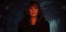 a close up of a woman 's face in a dark room .