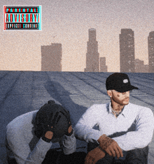 two men are sitting on a roof with an advisory sticker