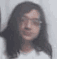 a blurry picture of a man with long hair and glasses