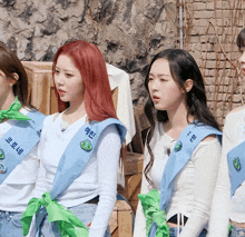a girl with red hair is wearing a sash that says " hee " on it
