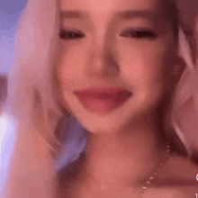 a close up of a woman 's face with her tongue out and a pink background .