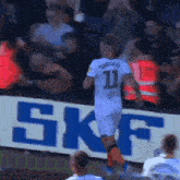 a soccer player wearing a number 11 jersey runs across the field