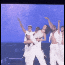 a man is carrying a woman on his shoulders on a stage .