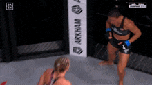 two women in a boxing ring with a banner that says arkham