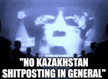 a group of people are sitting in front of a screen that says no kazakhstan shitposting in general