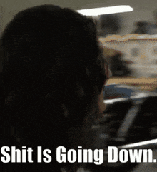 a blurred image of a woman with the words " shit is going down " below her