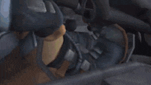 a tractor is sitting in a garage with a broken windshield and a broken tire .