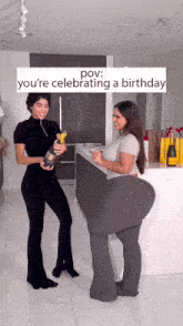 two women standing next to each other with one holding a bottle of champagne