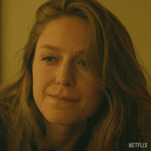 a close up of a woman 's face with netflix written on the bottom right