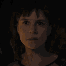 a close up of a woman 's face with a shocked look on her face
