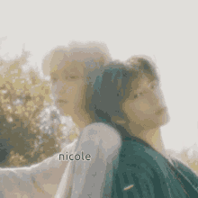 a couple of people standing next to each other with the name nicole written on the bottom