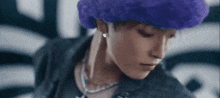 a close up of a person wearing a purple wig and a black jacket .