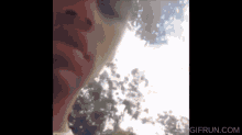 a close up of a person 's face with a gifrun.com watermark