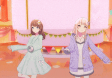 two anime girls are dancing on a stage with a pink background