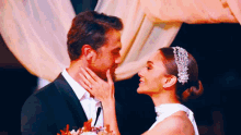 a bride and groom are looking into each other 's eyes at their wedding