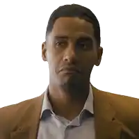a man in a suit and white shirt is making a funny face