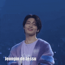 a young man wearing a purple cardigan and a purple shirt with the name jeongin de lessu