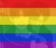 two people are hugging in front of a rainbow flag