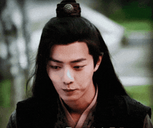 a young man with long hair has a crown on his head