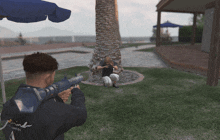 a man holding a gun in a video game with the word mind on the back of his shirt